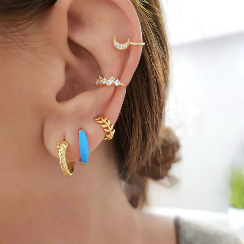 A pair of U-shaped geometric earrings with a glossy oval centre, in a choice of seven epoxy resin colours.