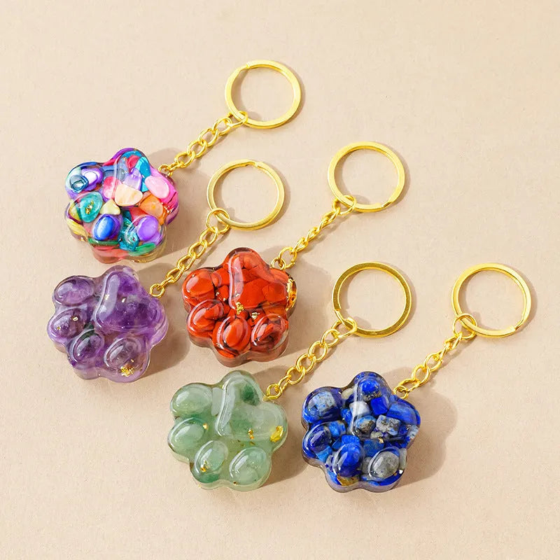 Natural crystal cat's paw keychain pendant on a stainless steel ring, showing detailed carving.