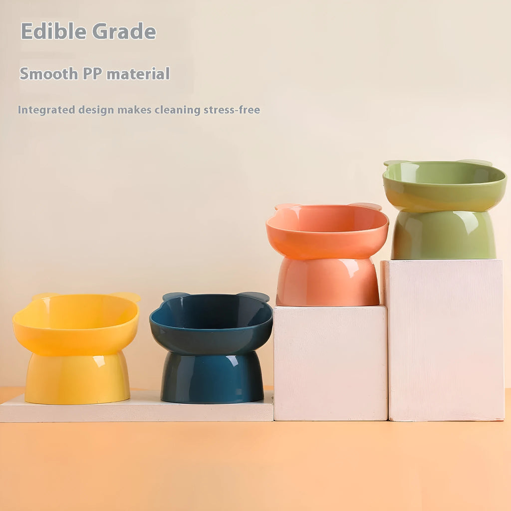 Oblique high foot pet bowl in PP for cats and dogs, shown in one of four colours: rouge pink, deep sea blue, lemon yellow or green grass green.