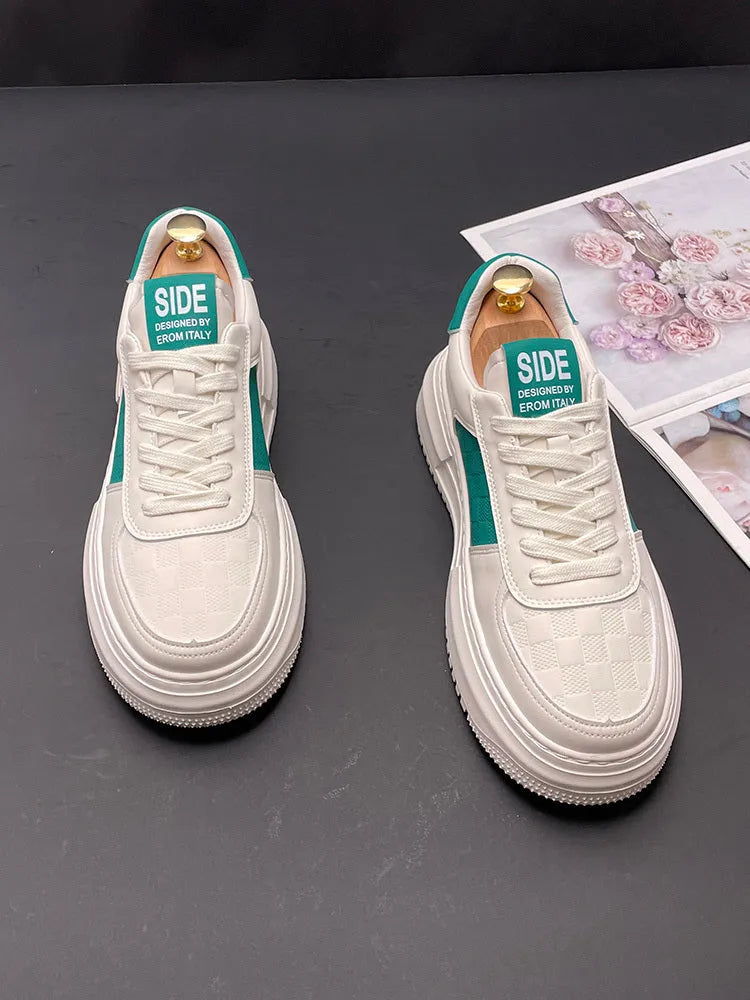 A pair of unisex casual shoes in white with green trim, featuring a cloth upper and rubber sole.