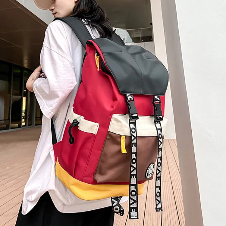 A black Oxford cloth backpack showing its size, carried over one shoulder.