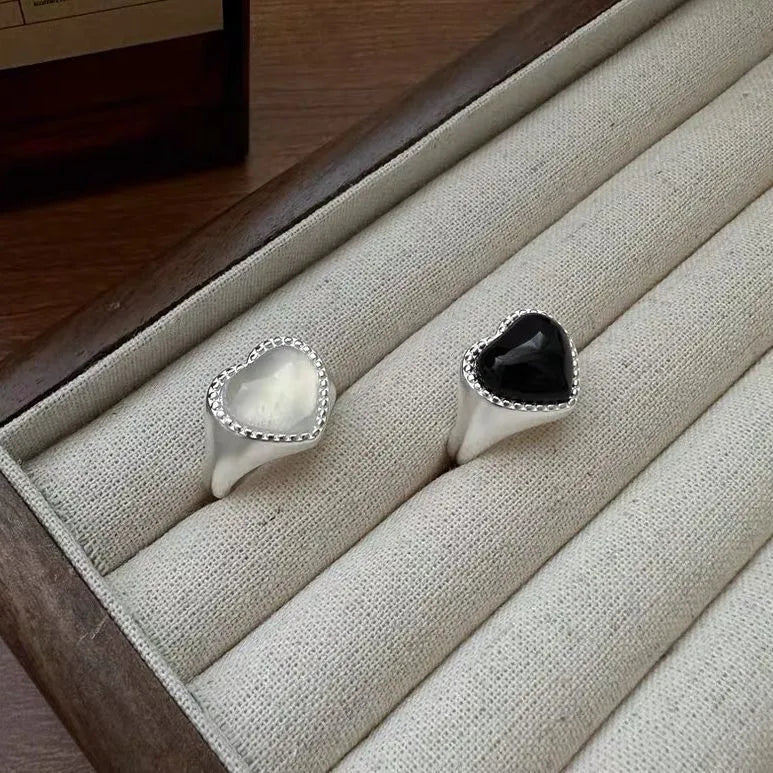 Sterling silver adjustable ring with black agate heart centrepiece on finger