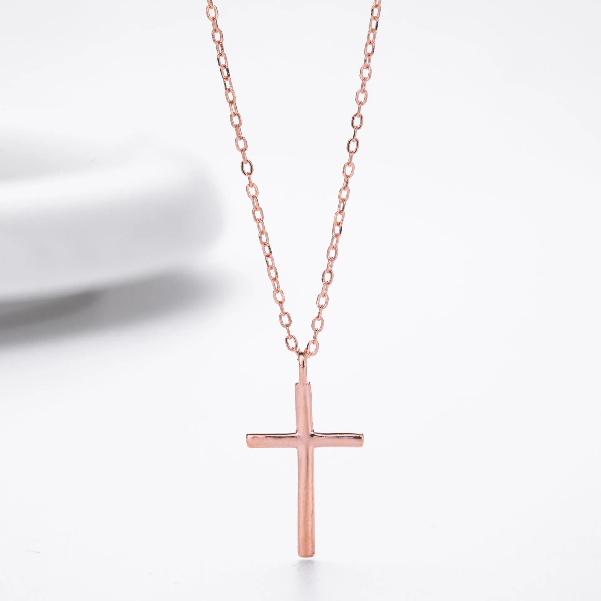 S925 sterling silver necklace with a simple glossy cross pendant on an O-shaped clavicle chain.