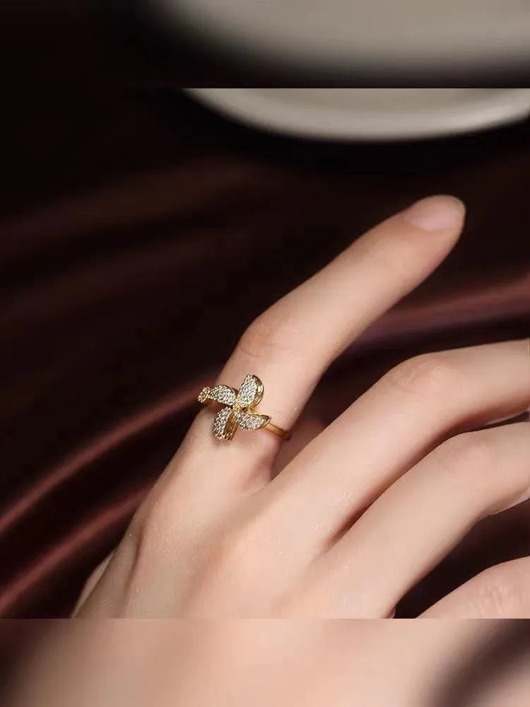 Gold and silver rotating windmill rings showing the spinning geometric copper design.