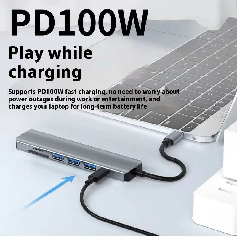 Silver 7-in-1 USB-C expansion dock with HDMI, VGA, USB ports, and a short 15cm connecting cable.