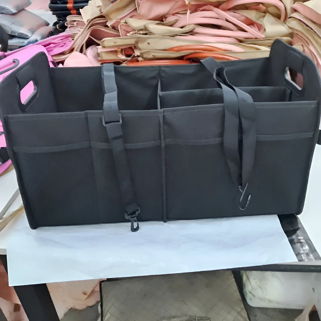 Foldable multi-compartment car boot storage box in black with handle and waterproof fabric construction