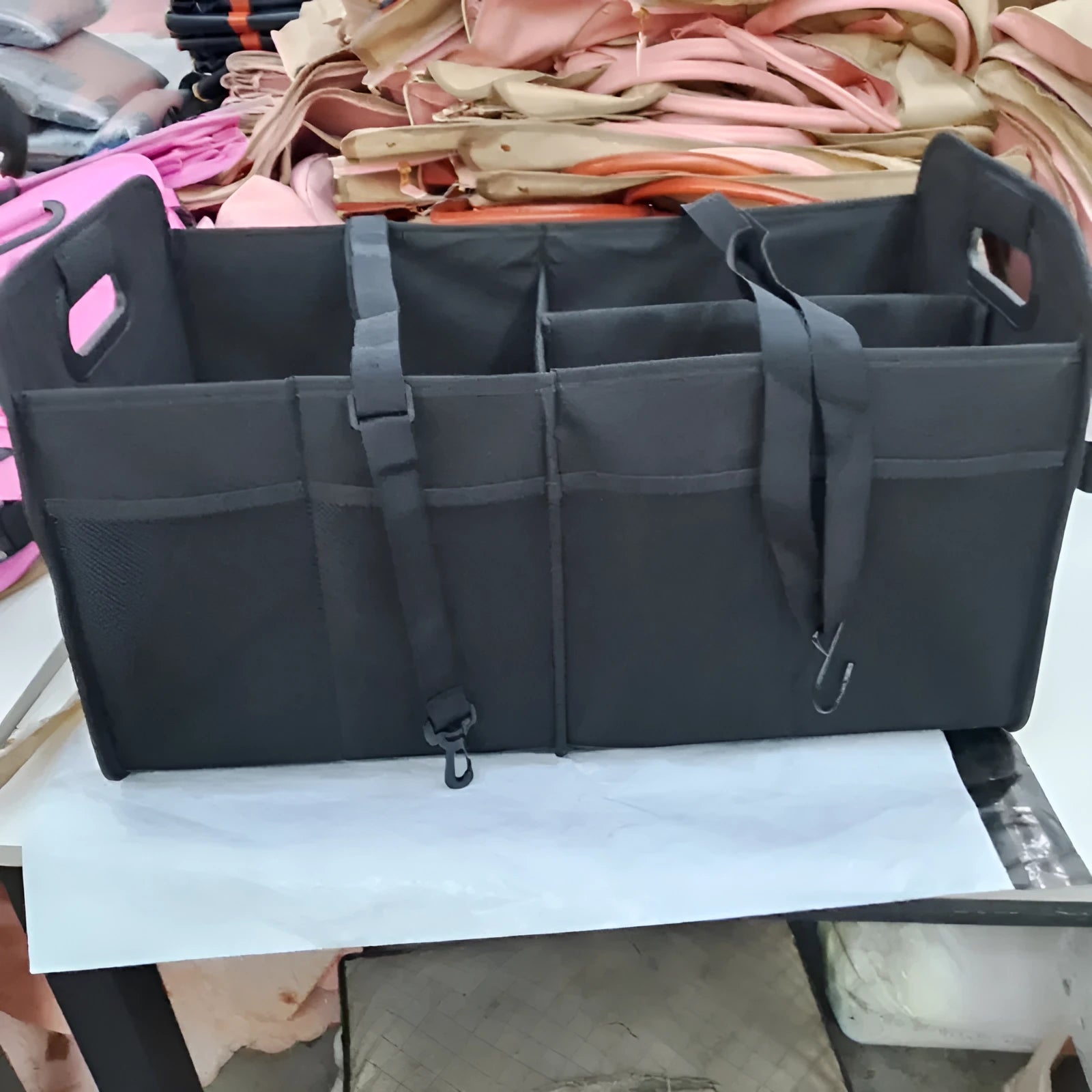 Foldable multi-compartment car boot storage box in black with handle and waterproof fabric construction