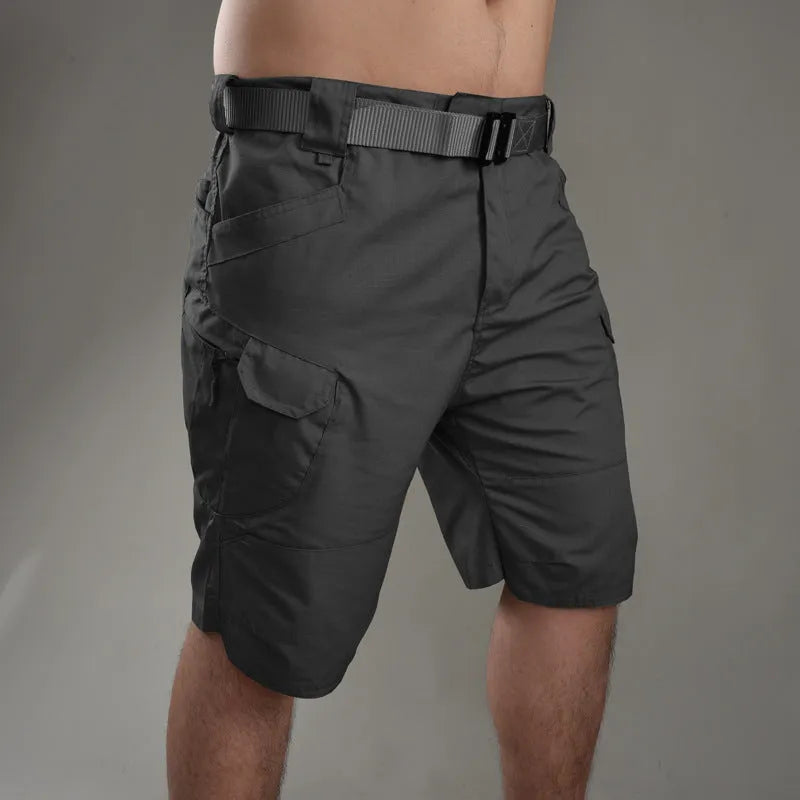 IX7 men's tactical shorts in cotton blend fabric, shown in a camouflage colour with button-fly closure.