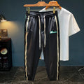 Men's solid black cotton harem trousers with a mid-waist and loose fit.