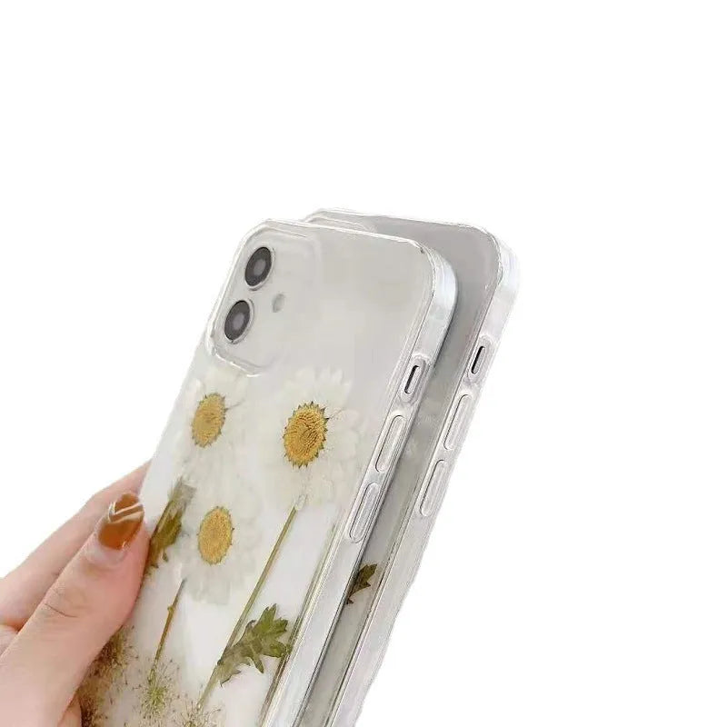 White TPU iPhone case with a raised epoxy daisy floral design on the back.