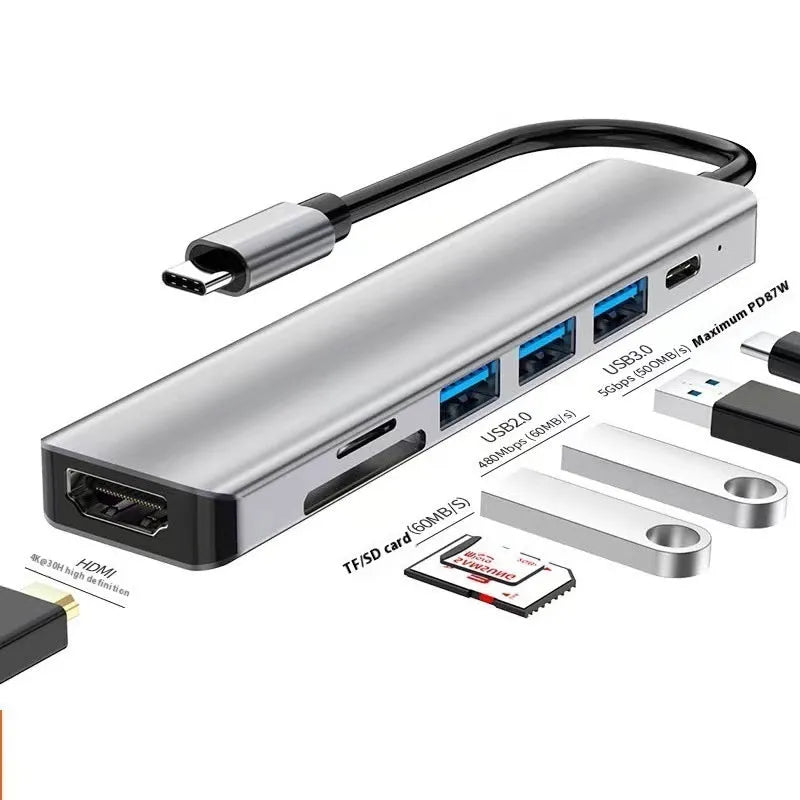 Silver 7-in-1 USB-C expansion dock with HDMI, VGA, USB ports, and a short 15cm connecting cable.