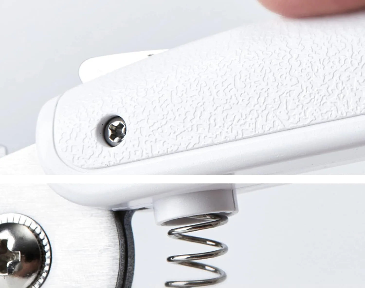 White pet nail clippers with LED light and transparent guard, shown with a separate nail file on a table.