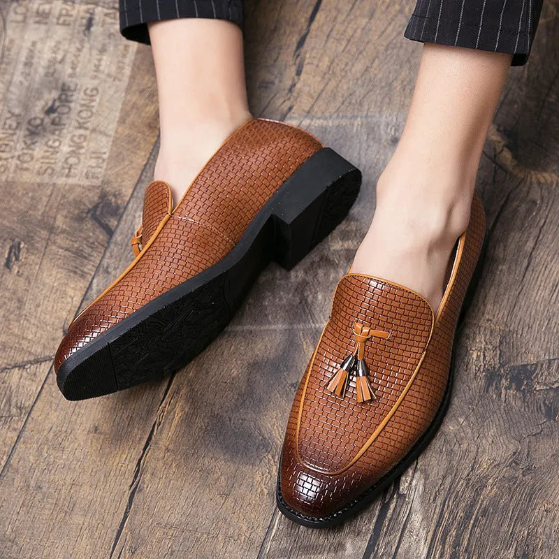 Men's black pointed toe slip-on shoes with a tassel detail on the artificial PU upper.