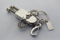 Metal robot U disk in silver with spring-extended USB connector on a white background