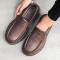 Men's black slip-on work shoes with a platform sole and round toe.