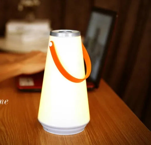 White rechargeable LED night light with touch controls measuring 12x12x22cm
