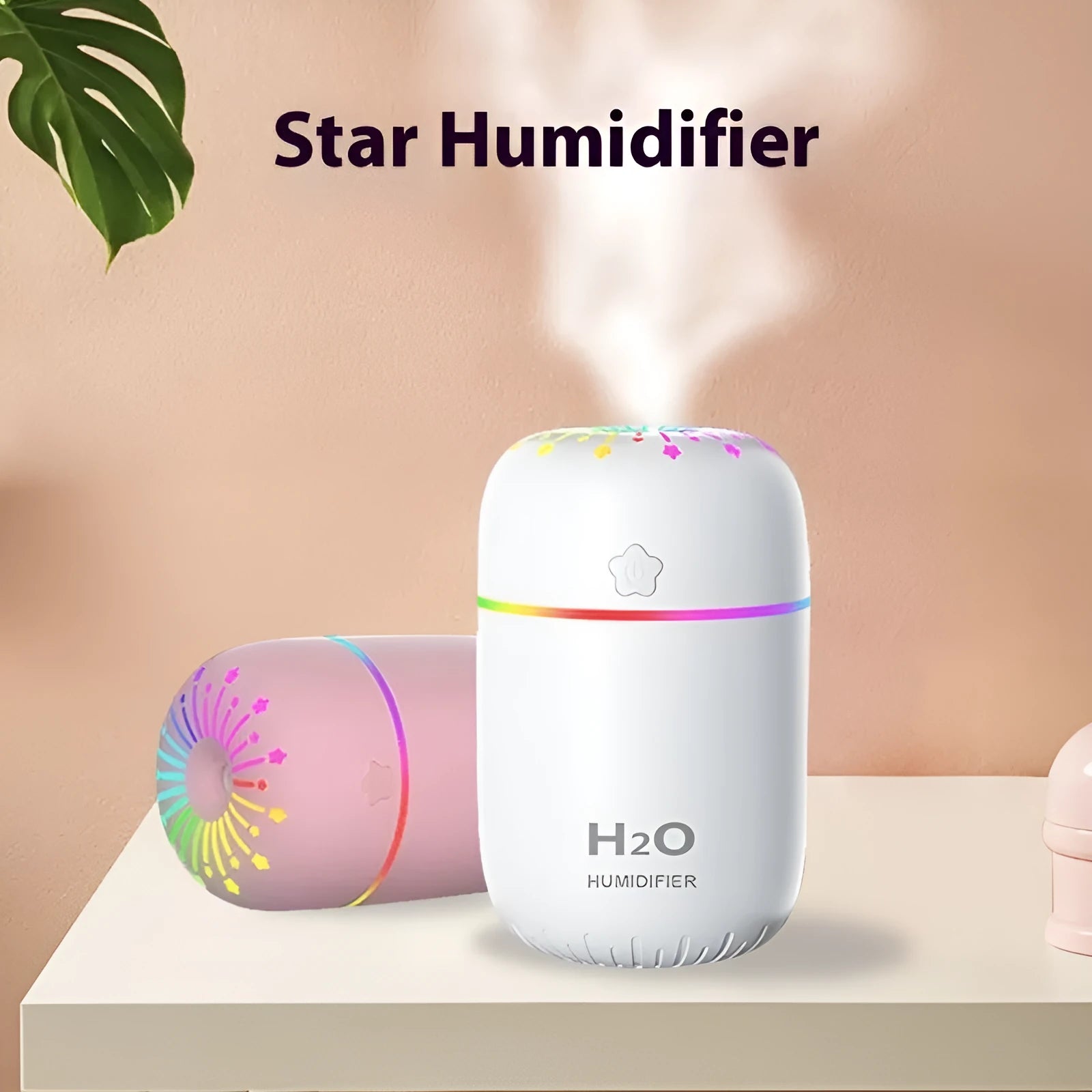 Compact white USB mini humidifier with water tank on a desk next to a laptop.