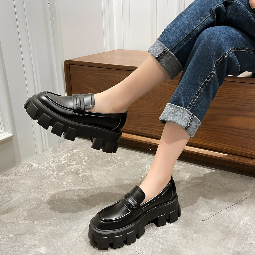 British style wide fit loafers in matte or patent leather with a rubber sole and muffin heel.