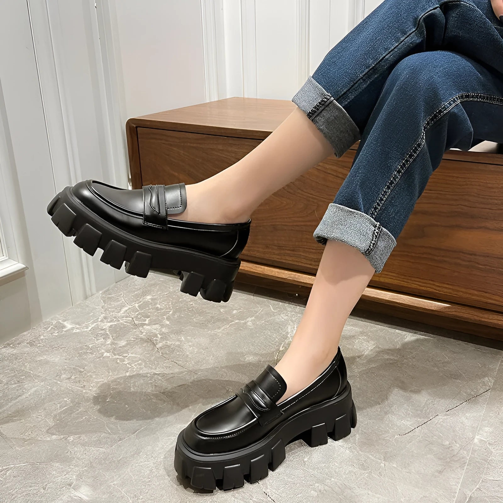 British style wide fit loafers in matte or patent leather with a rubber sole and muffin heel.