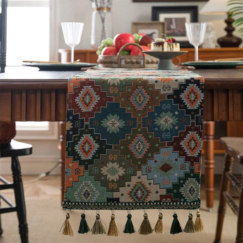 Rhyme Nordic striped jacquard table runner with tassel fringe in dark blue on a wooden table.