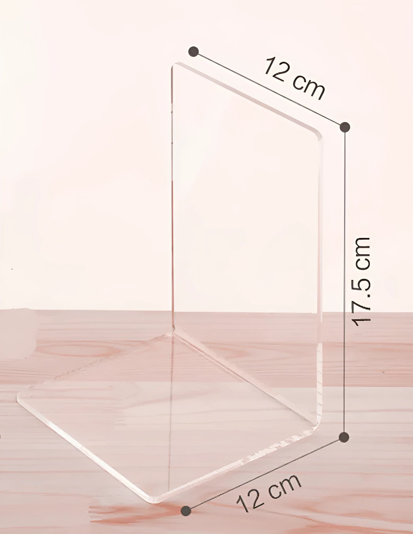Transparent acrylic bookshelf display rack on a desk holding two books.