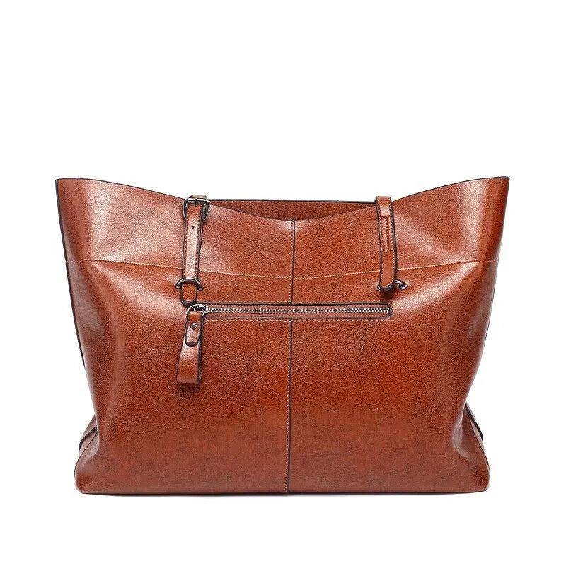 Brown waxed cowhide cross-body leather handbag showing front view with strap, measuring 30cm wide by 37cm tall.