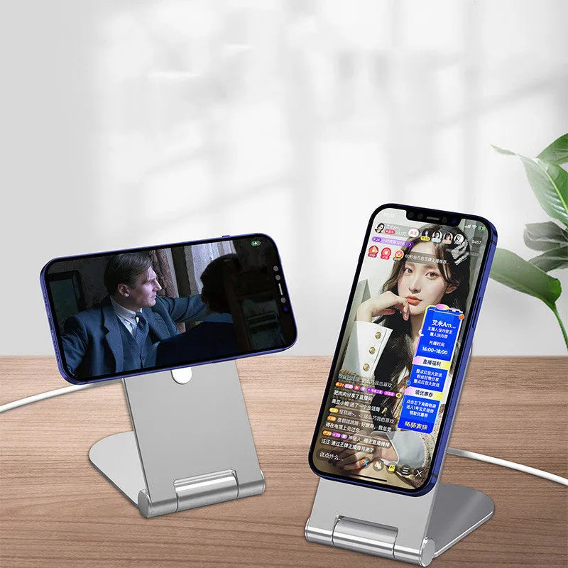 Silver vertical adjustable magnetic phone mounting bracket for iPhone12 on a desk.