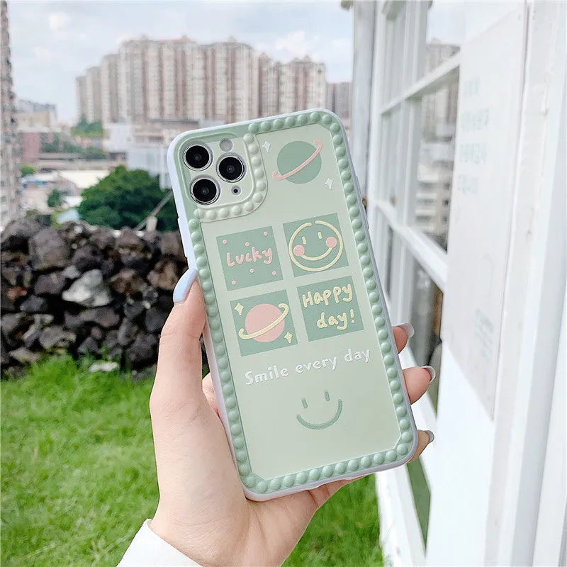 Green TPU iPhone case with geometric smiley face and polka dot frame design