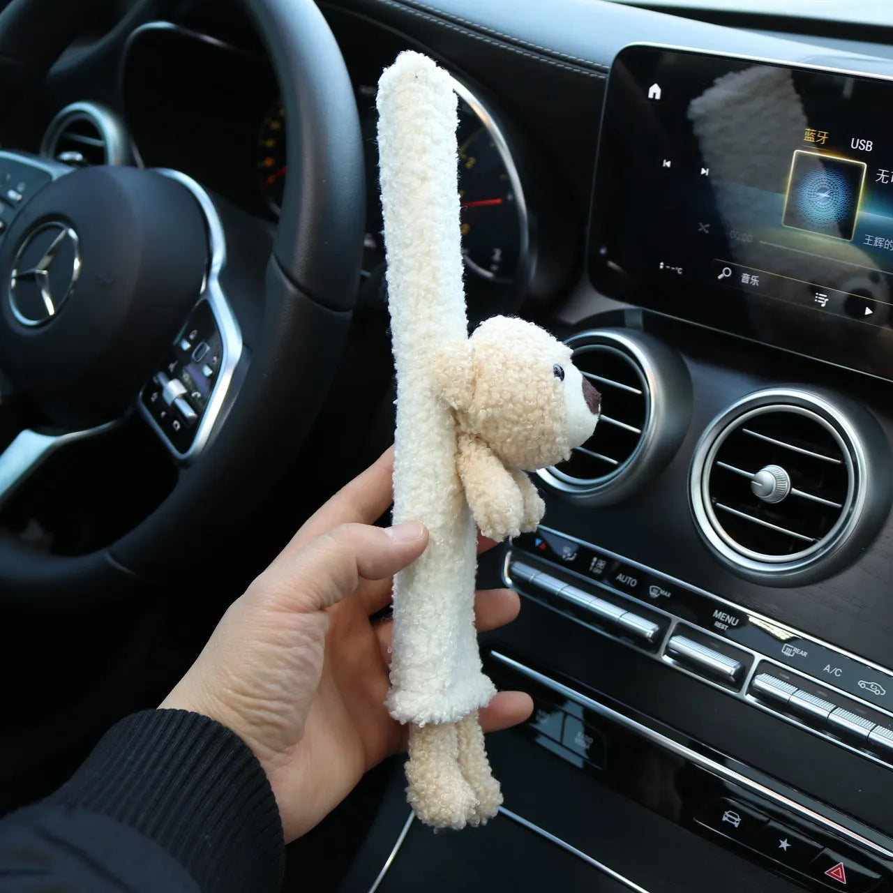 Cartoon plush lamb wool seat belt shoulder protector cover in Bear design on a car seat.