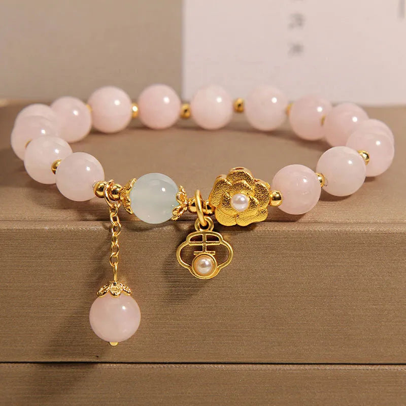 Women's pink crystal flower bracelet with a refined grace design on a wrist.