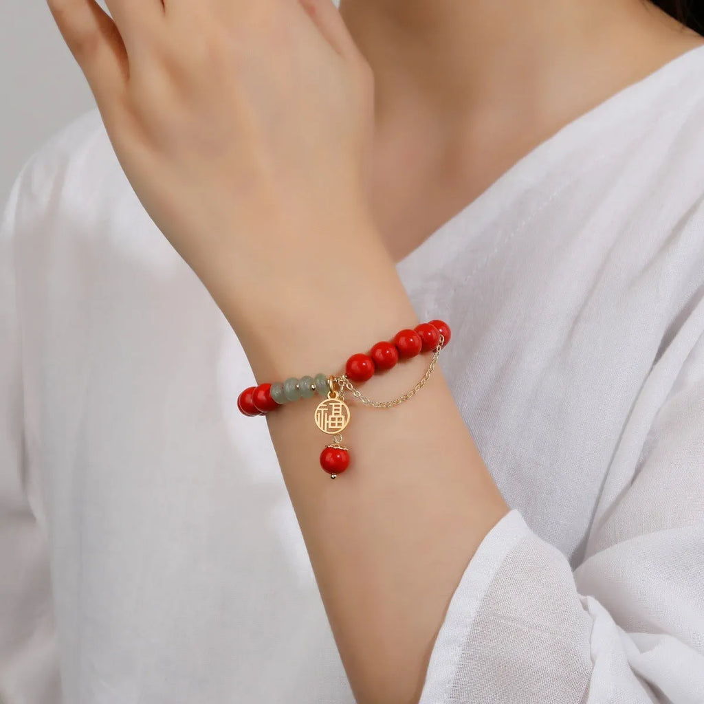 Women's red sand cinnabar bracelet with fu character charm and jade spacer