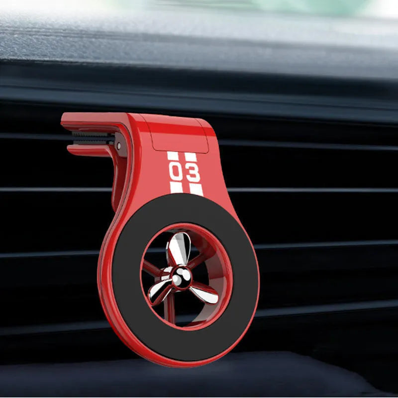 Black magnetic phone holder clipped onto a car air vent, showing phone attached and 360-degree rotation.