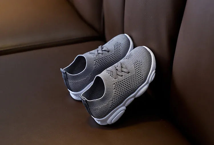 Children's lazy slip-on shoes in fabric with non-slip rubber sole, shown in available colours.