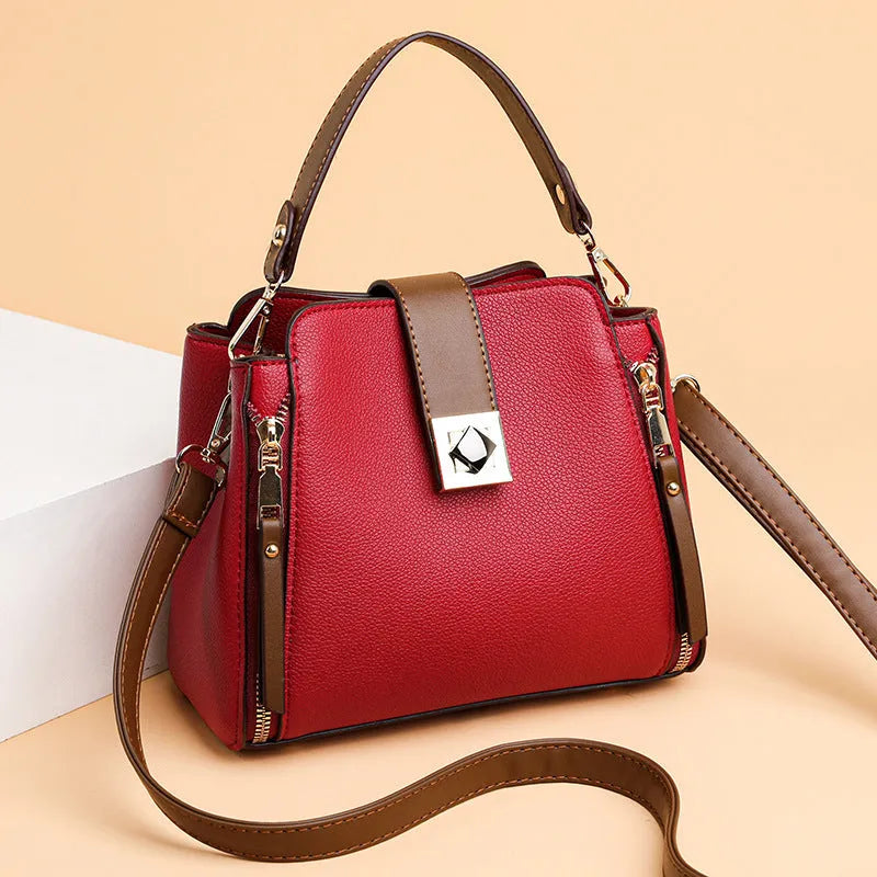 Women's large-capacity PU crossbody bucket bag with three-dimensional outer pocket and splicing detail, shown in black, red, or blue