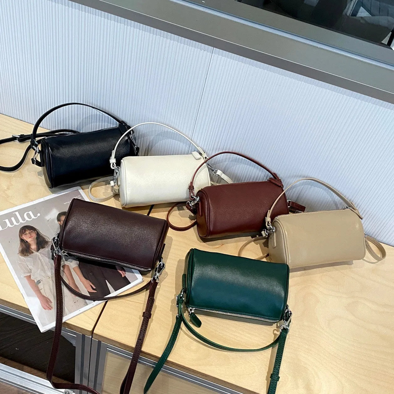 Genuine leather mobile phone crossbody bag with cylindrical design in six colour options showing sewing thread detailing