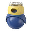 Morandi yellow and blue owl-shaped plastic tumbler cat toy with a snap-fit lid, on a wooden floor.