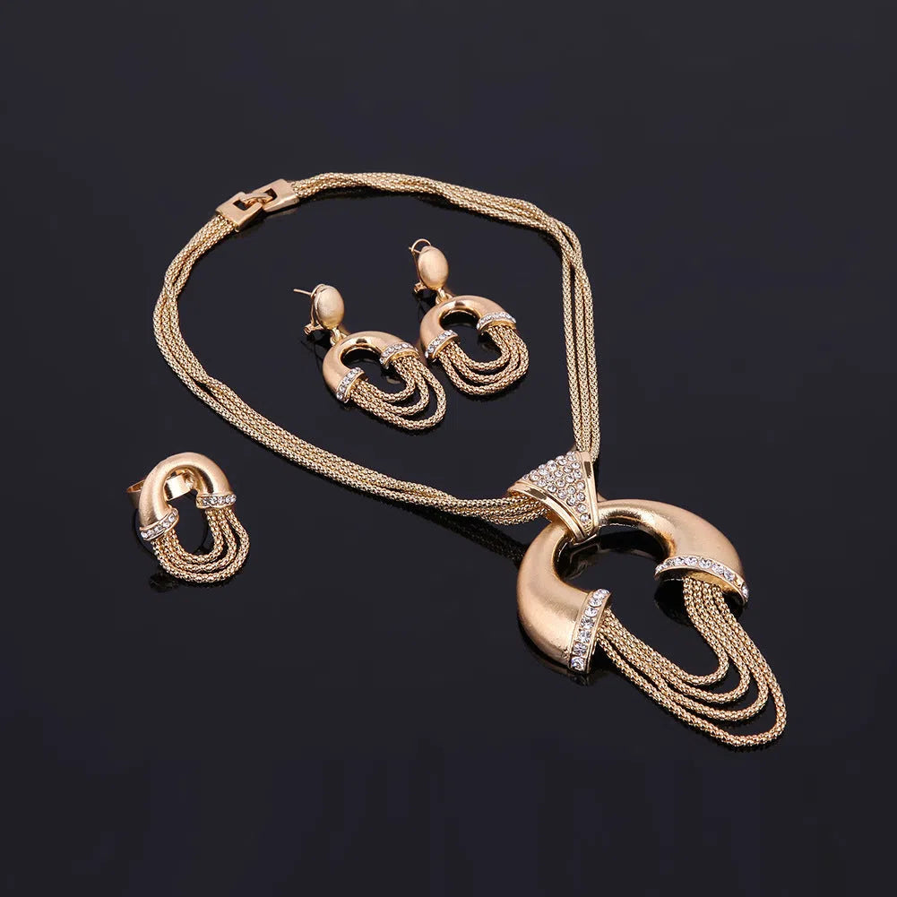 Four-piece alloy bridal jewellery set in 18K gold colour with artificial gem inlay and extension chain