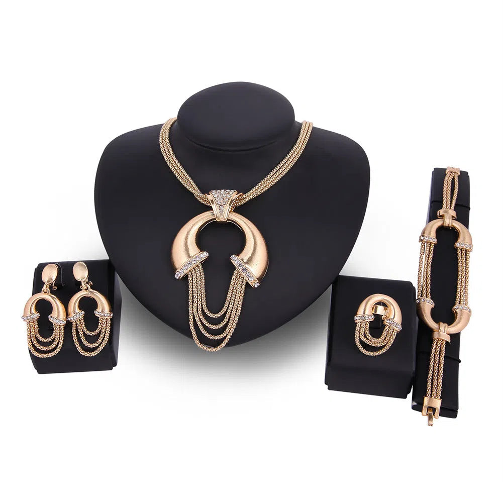 Four-piece alloy bridal jewellery set in 18K gold colour with artificial gem inlay and extension chain