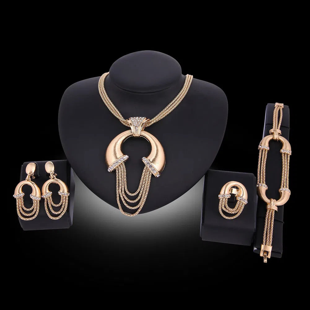Four-piece alloy bridal jewellery set in 18K gold colour with artificial gem inlay and extension chain