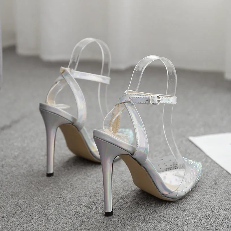 Women's pointed toe stiletto sandals with crystal diamond decoration on a PVC upper.