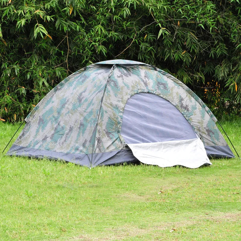 Green camouflage two-person tent with mesh windows, pitched outdoors.