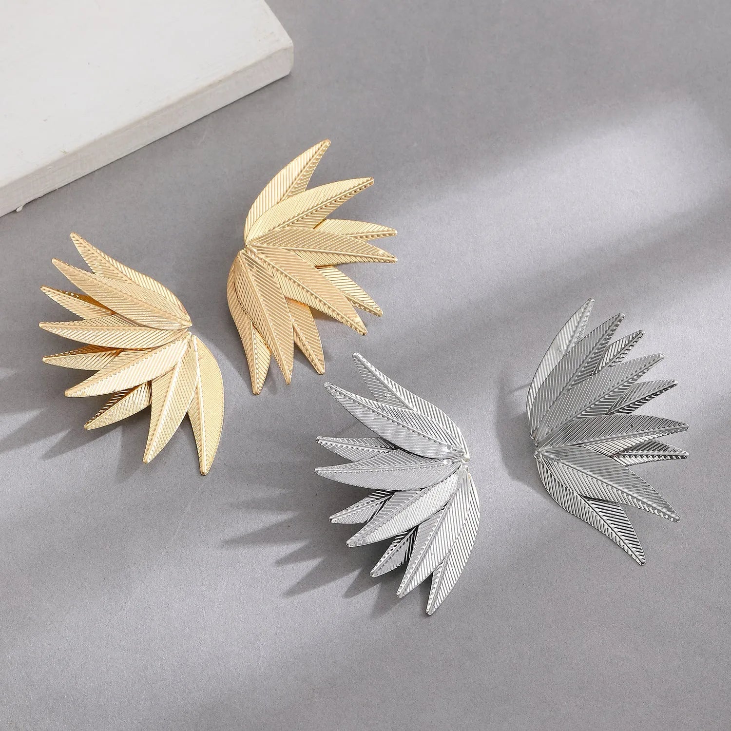 Gold and white leaves patch earrings showing detailed leaf design on alloy metal