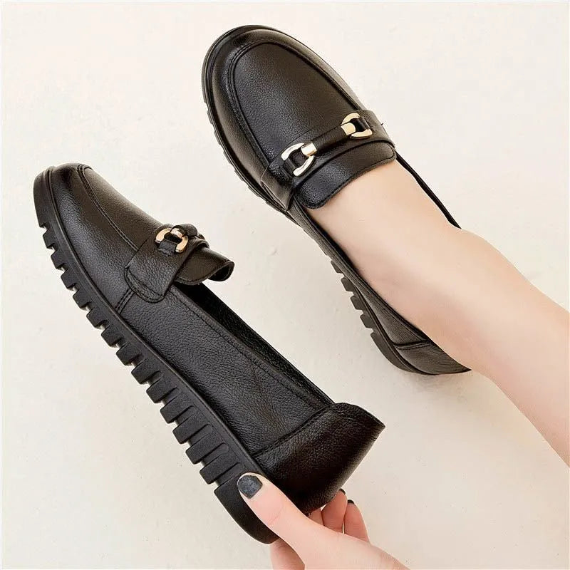Black women's casual slip-on pumps with round toe and low flat heel on a rubber sole.