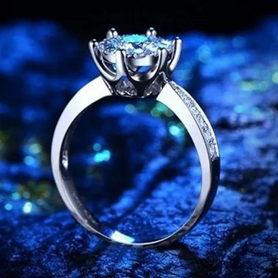 Sterling silver engagement ring with eight heart eight arrow cut zircon gem on white background
