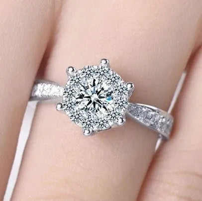 Sterling silver engagement ring with eight heart eight arrow cut zircon gem on white background