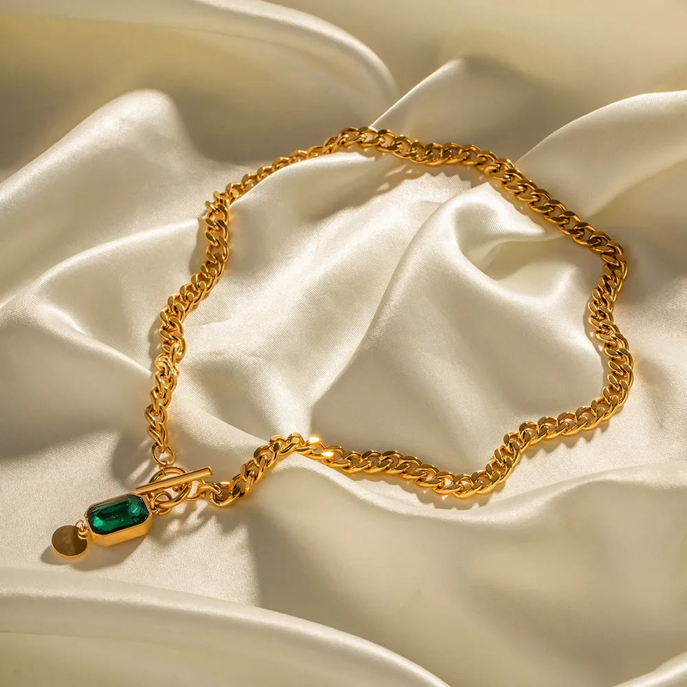 Gold geometric zircon pendant necklace with Cuban chain on white background