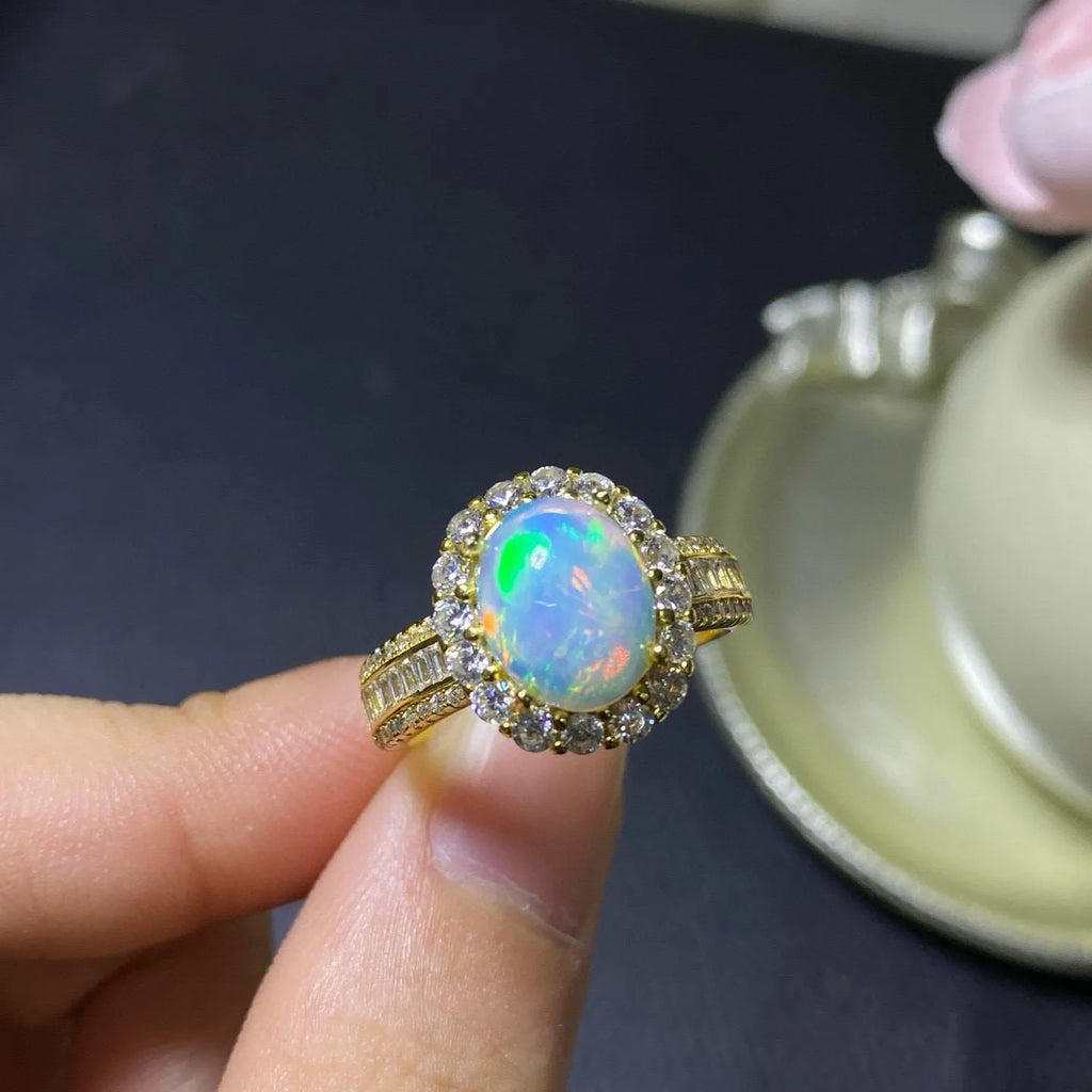 Handmade adjustable silver ring with a natural opal, shown in rose gold plating.