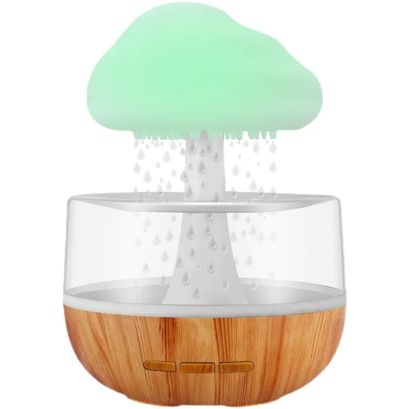 White cloud-shaped humidifier with coloured night light on a table.