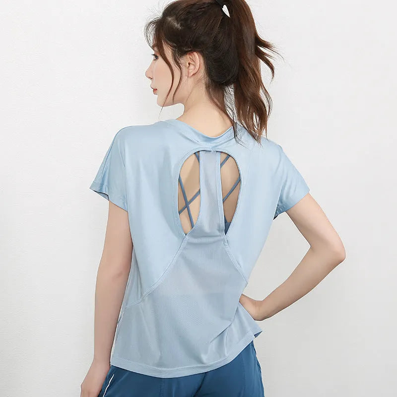 Women's short sleeve polyester sports t-shirt in pink, shown for fitness and leisure wear.