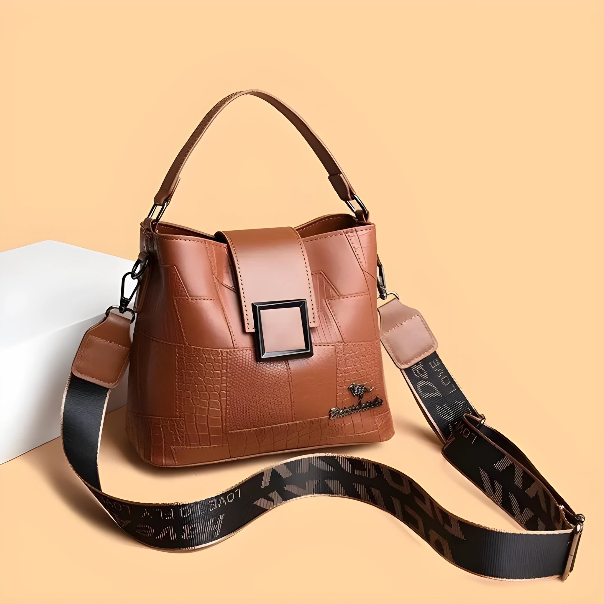 PU leather crossbody handbag with sewing line detail in brown, showing outer sandwich pocket and adjustable strap against neutral background